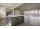 Spacious kitchen featuring large island, sleek countertops, stainless steel appliances, and open floor plan at 10972 N Hershey St, Surprise, AZ 85388