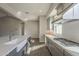 Modern kitchen featuring sleek gray cabinetry, quartz countertops, stainless steel appliances and stylish tile backsplash at 10972 N Hershey St, Surprise, AZ 85388