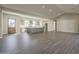 Open-concept living area features wood-look tile flooring and neutral colors, creating a warm and inviting space at 10972 N Hershey St, Surprise, AZ 85388