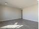 A neutral room featuring wood-look tile flooring, ideal for creating a personalized living space at 10972 N Hershey St, Surprise, AZ 85388