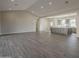 Large open living area showcasing tile floors and lots of natural light with kitchen in background at 10972 N Hershey St, Surprise, AZ 85388