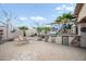 Outdoor kitchen and bar area features built-in grill, fridge, and a cozy fire pit for entertaining at 11122 N 165Th Ave, Surprise, AZ 85388