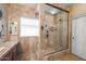 Tiled bathroom with a glass-enclosed shower and a vanity with a granite countertop at 11122 N 165Th Ave, Surprise, AZ 85388