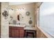 Well lit bathroom featuring dual sinks, granite counters, decorative mirrors, and a separate vanity area at 11122 N 165Th Ave, Surprise, AZ 85388