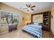 Bright bedroom with a built-in wardrobe, a ceiling fan and natural light streaming through the window at 11122 N 165Th Ave, Surprise, AZ 85388