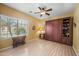 Cozy bedroom with built-in wardrobe, a ceiling fan, and natural light streaming through the window at 11122 N 165Th Ave, Surprise, AZ 85388