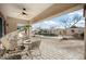 Relaxing covered patio with ceiling fan, lounge seating, and a beautiful view of the backyard pool area at 11122 N 165Th Ave, Surprise, AZ 85388