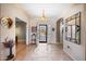 Open foyer with decorative tiled floor, arched doorways, and view through the iron-grilled front door to the front yard at 11122 N 165Th Ave, Surprise, AZ 85388