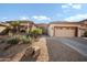 Charming single-story home featuring manicured landscaping, a two-car garage, and a welcoming entrance at 11122 N 165Th Ave, Surprise, AZ 85388