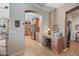 Hallway with a view into the kitchen and a work desk area with granite countertop in the hall, and arched entryway at 11122 N 165Th Ave, Surprise, AZ 85388