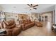 Inviting living room with leather seating, open layout, and seamless flow into the kitchen and dining area at 11122 N 165Th Ave, Surprise, AZ 85388