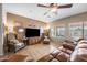 Inviting living room with cozy furniture, ceiling fan, and natural light from the windows with a view to the pool at 11122 N 165Th Ave, Surprise, AZ 85388