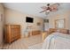 Comfortable main bedroom with wooden furniture, fan, and plenty of natural light at 11122 N 165Th Ave, Surprise, AZ 85388