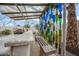 Outdoor kitchen featuring bar, bench, grill, and creative bottle wall art at 11122 N 165Th Ave, Surprise, AZ 85388