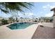 Backyard pool with an attractive tile waterfall feature, desert plants, and a surrounding patio area at 11122 N 165Th Ave, Surprise, AZ 85388