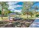 Community park featuring a covered picnic area with seating nestled in lush green space with walking path at 1133 N Florence Dr, Chandler, AZ 85226