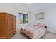 Bright bedroom featuring a bed with a floral comforter, wood dresser and a window at 11616 N Saguaro Blvd # 2, Fountain Hills, AZ 85268