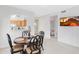 This bright dining room features a round table with seating for four, and a view into the kitchen and living areas at 11616 N Saguaro Blvd # 2, Fountain Hills, AZ 85268