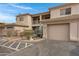 Exterior view of condo building featuring tan stucco, covered parking, and desert landscaping at 11616 N Saguaro Blvd # 2, Fountain Hills, AZ 85268