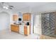 Bright and airy kitchen with wood cabinets and a view of the backyard through the sliding glass door at 11616 N Saguaro Blvd # 2, Fountain Hills, AZ 85268