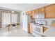 Cozy kitchen featuring white appliances, wood cabinets, and an adjacent dining area at 11616 N Saguaro Blvd # 2, Fountain Hills, AZ 85268