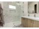 Bathroom with glass shower, double sink vanity, and neutral colored tile at 12240 N 62Nd Pl, Scottsdale, AZ 85254