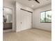 A bright bedroom with hardwood floors and an en-suite bathroom with neutral finishes, and white walls at 12240 N 62Nd Pl, Scottsdale, AZ 85254