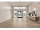 Bright foyer featuring a stone accent wall, modern light fixture, and wood-look flooring at 12240 N 62Nd Pl, Scottsdale, AZ 85254