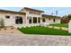 Contemporary home with a stone accent wall, lush green lawn, and modern landscaping at 12240 N 62Nd Pl, Scottsdale, AZ 85254