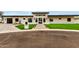 Modern home featuring a stone facade, black-framed windows, well-manicured lawn, and a brick pathway at 12240 N 62Nd Pl, Scottsdale, AZ 85254