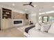 Cozy living room featuring a fireplace, built-in shelving, neutral decor, and lots of natural light at 12240 N 62Nd Pl, Scottsdale, AZ 85254