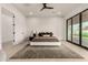 Bright main bedroom with white walls and a large sliding glass door to the backyard at 12240 N 62Nd Pl, Scottsdale, AZ 85254