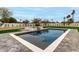 Modern pool with stone surround and integrated spa features a spacious patio for outdoor entertaining at 12240 N 62Nd Pl, Scottsdale, AZ 85254