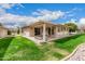 Manicured backyard featuring a covered patio and lush green lawn at 12810 W Ashwood Dr, Sun City West, AZ 85375