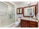 Bathroom featuring a glass-enclosed shower, granite countertop vanity, and neutral tile flooring at 12810 W Ashwood Dr, Sun City West, AZ 85375