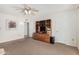 Neutral bedroom with built-in media center and ceiling fan for added comfort at 12810 W Ashwood Dr, Sun City West, AZ 85375