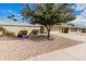 Well-maintained home featuring desert landscaping, a mature shade tree, and a welcoming facade at 12810 W Ashwood Dr, Sun City West, AZ 85375