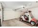 Spacious garage featuring a golf cart and automatic door opener at 12810 W Ashwood Dr, Sun City West, AZ 85375