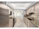 Charming kitchen with stainless steel appliances, light wood cabinets, and a decorative tile backsplash at 12810 W Ashwood Dr, Sun City West, AZ 85375