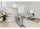 Functional laundry room with modern appliances, sink, and ample storage at 12810 W Ashwood Dr, Sun City West, AZ 85375