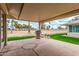 Shaded patio area great for relaxing, showcasing an outdoor grill and green landscape at 12810 W Ashwood Dr, Sun City West, AZ 85375