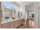 Bright bathroom featuring a double sink vanity, ample counter space, and a large window at 14314 W Pecos Ln, Sun City West, AZ 85375