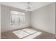 Bright bedroom featuring a ceiling fan and a window allowing natural light at 14314 W Pecos Ln, Sun City West, AZ 85375