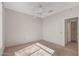 Clean bedroom featuring a ceiling fan, and a doorway that leads to a bathroom at 14314 W Pecos Ln, Sun City West, AZ 85375