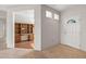 Bright entryway with tile floor and a white door leading to the outside and office area at 14314 W Pecos Ln, Sun City West, AZ 85375