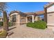 Close-up of a home's front exterior featuring desert landscaping at 14314 W Pecos Ln, Sun City West, AZ 85375