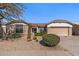 Well-maintained single-story home with desert landscaping, accentuated by a tile roof and a practical two-car garage at 14314 W Pecos Ln, Sun City West, AZ 85375