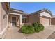 Close-up of a home's front exterior featuring desert landscaping and a 