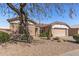 Well-kept single-story home with desert landscaping and a two-car garage at 14314 W Pecos Ln, Sun City West, AZ 85375