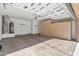 Spacious garage featuring built-in cabinets, water heater, and a clean concrete floor at 14314 W Pecos Ln, Sun City West, AZ 85375